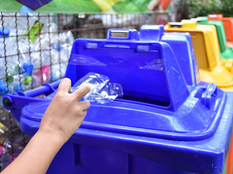 Person recycling a plastic water bottle